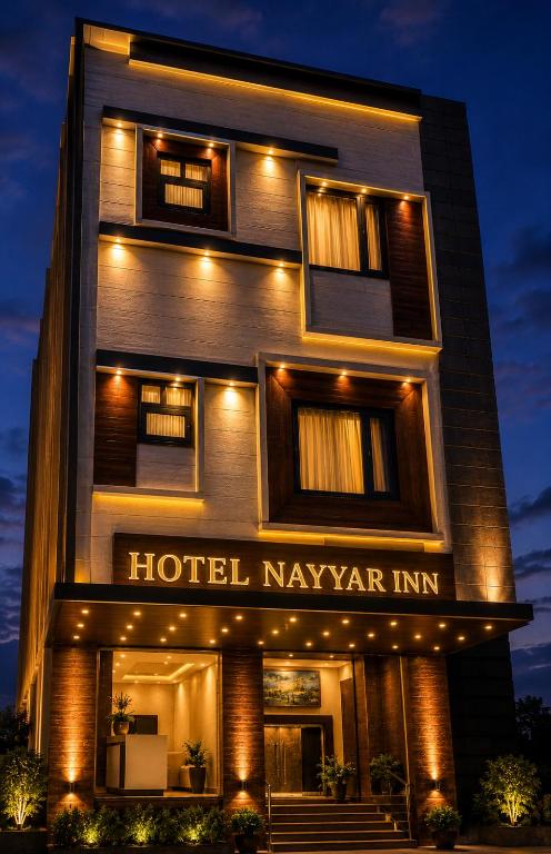 a hotel naygar inn is lit up at night at Hotel Nayyar Inn Near Golden temple in Amritsar