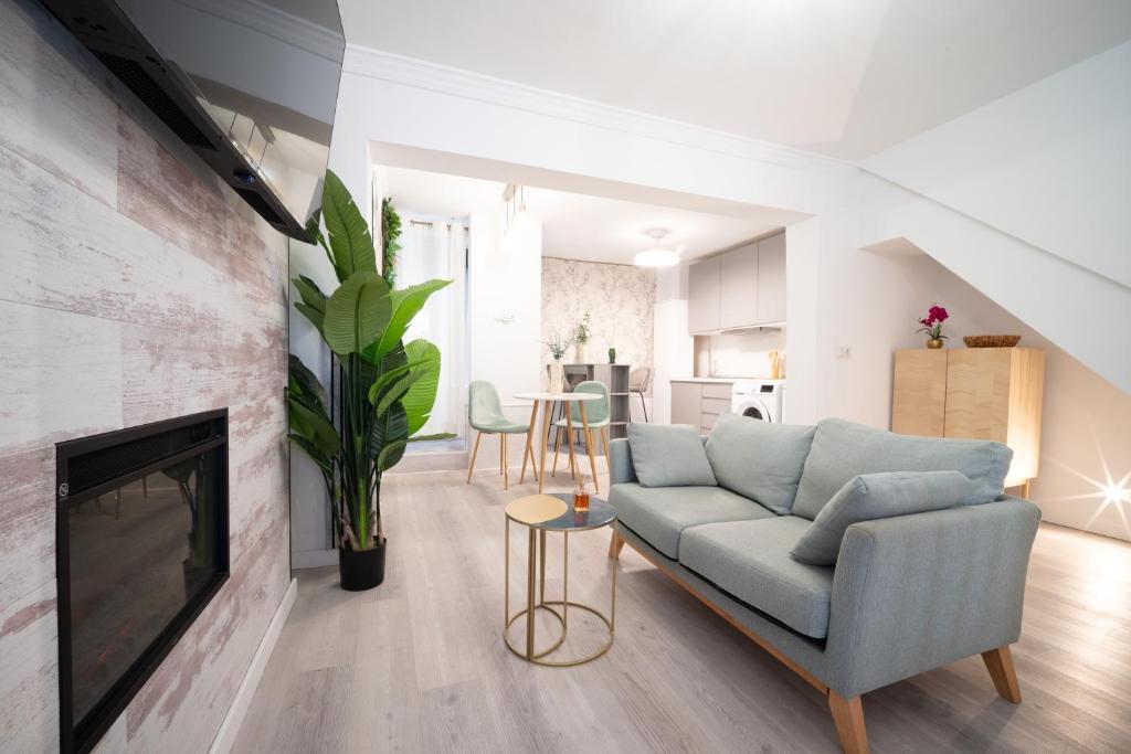 a living room with a couch and a fireplace at Luxer Holidays in Málaga