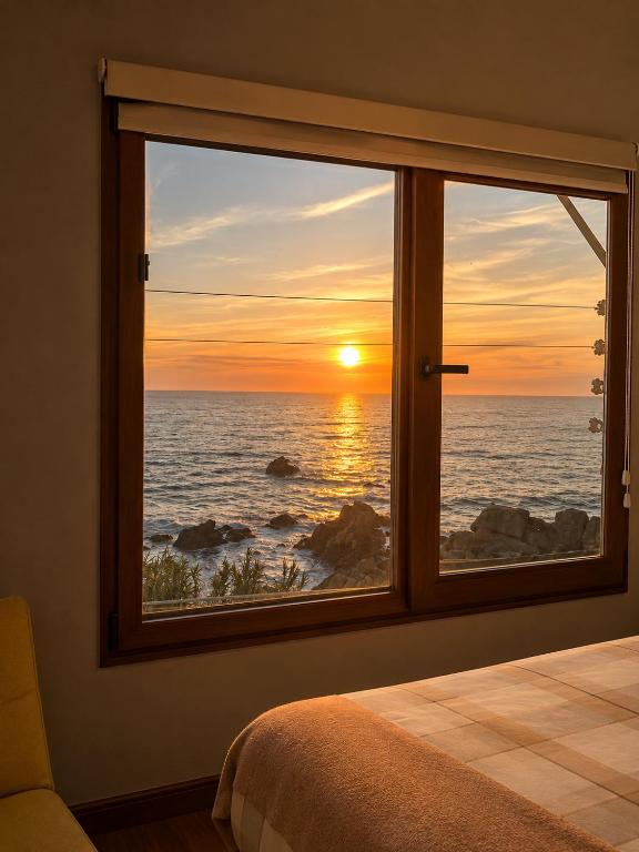 a bedroom window with a view of the ocean at Casa Vista Pacífico in Concón