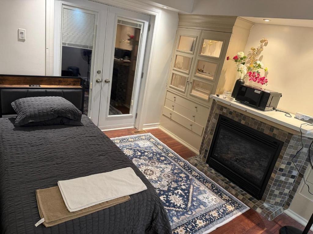 a bedroom with a bed and a fireplace at Your own home in Toronto