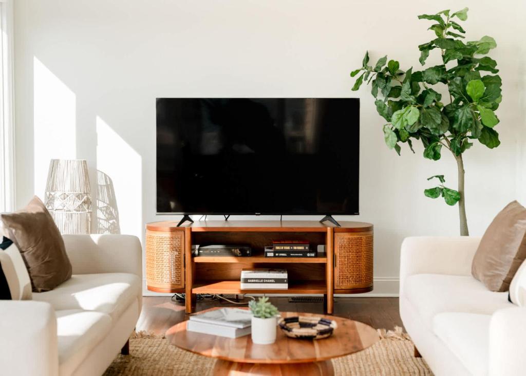 a living room with a flat screen tv at Marshfront 5BD Oasis Pool Yard & Steps to Beach in Folly Beach