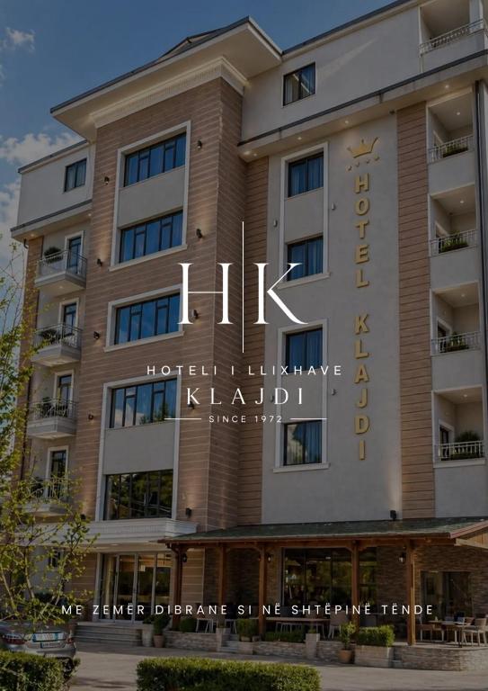 a hotel building with a sign that reads hotel initiative khalili at Hotel Klajdi in Peshkopi