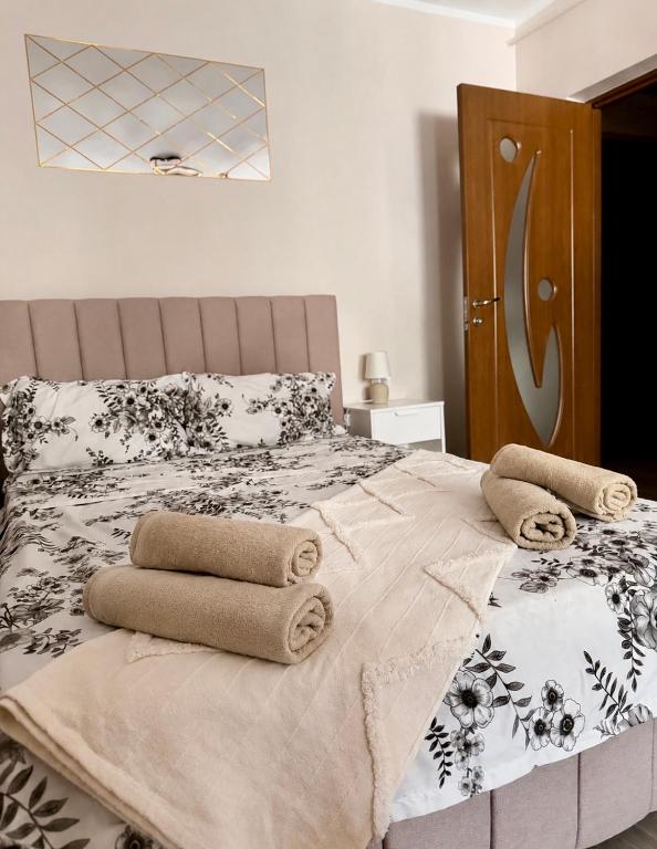 a bedroom with a bed with towels on it at Sofia Apartment in Galaţi