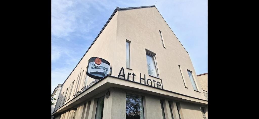 a tall building with a sign on the top of it at Art Hotel Podebrady in Poděbrady