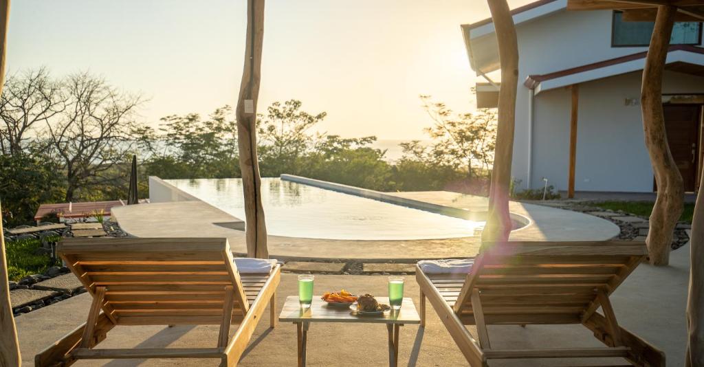 a patio with two chairs and a table and a skate ramp at Area 101 in Playa Pelada