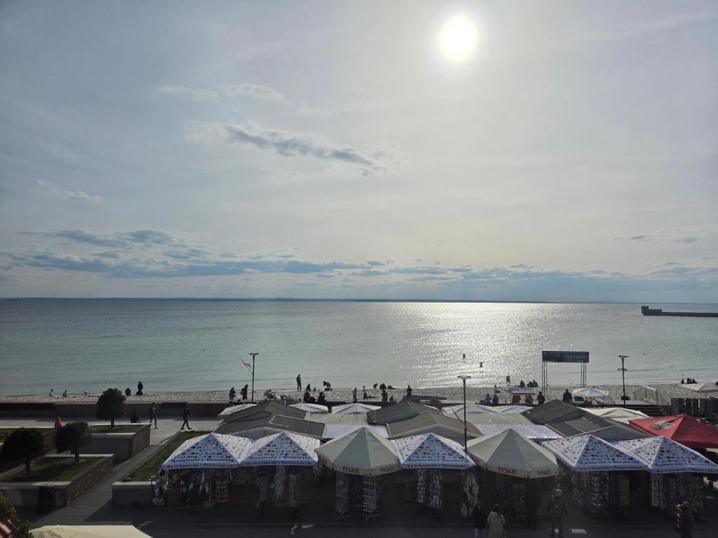 a view of a beach with people and the ocean at Apartament Gruba Foka in Hel