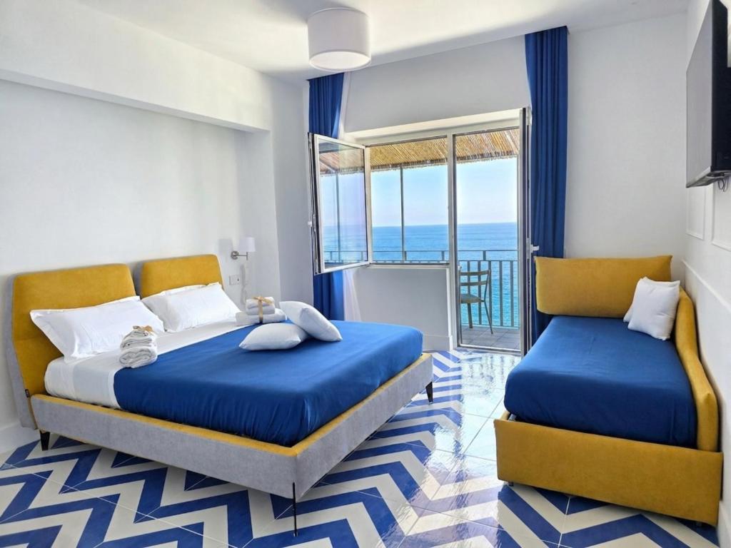 a bedroom with two beds and a balcony at Oasi Relais in Vico Equense