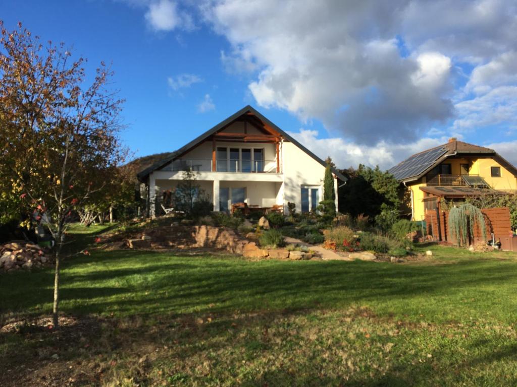 a house on a hill with a yard at Aura Vendégház in Révfülöp