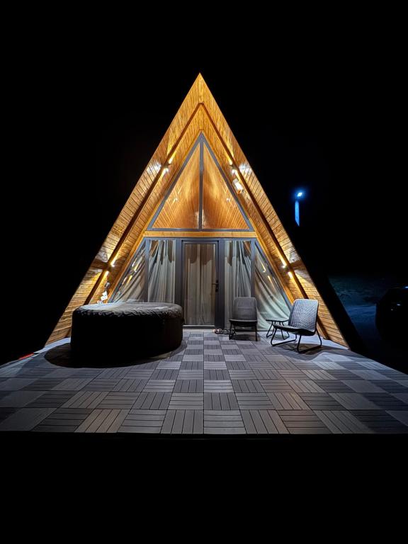 a tent with a bed and two chairs in it at Theforestheaven in Brđani
