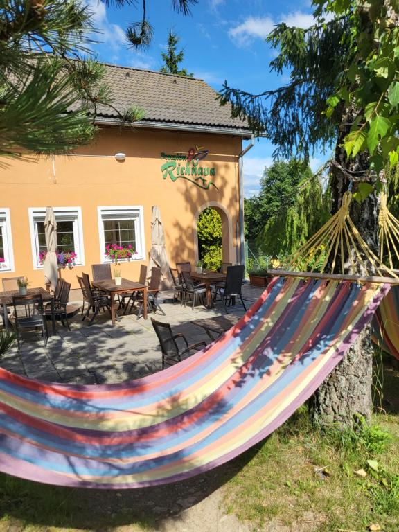 a colorful hammock in front of a house at Penzion Richnava in Štiavnické Bane