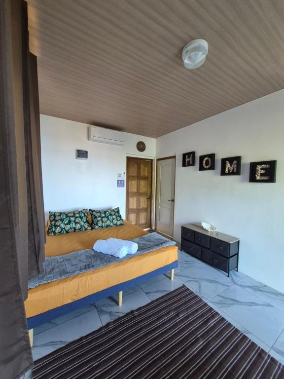 a bedroom with a large bed and a table at Fare Hanihau in Uturoa
