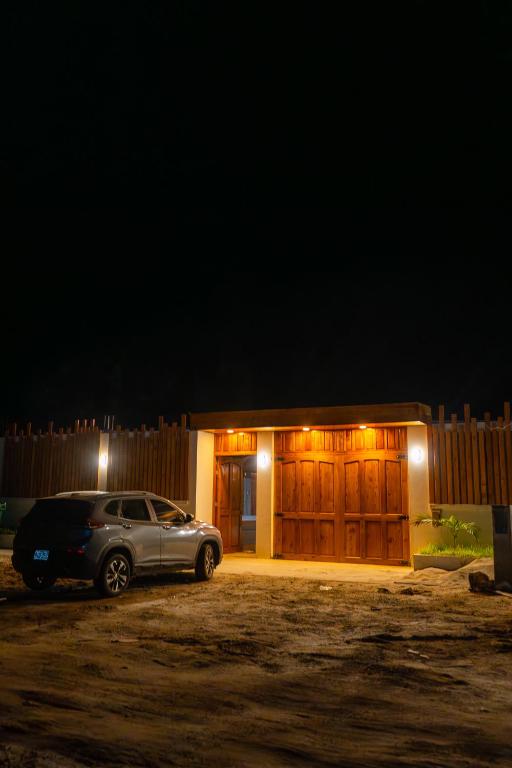 a car parked in front of a garage at night at Mar de Jade in Colán