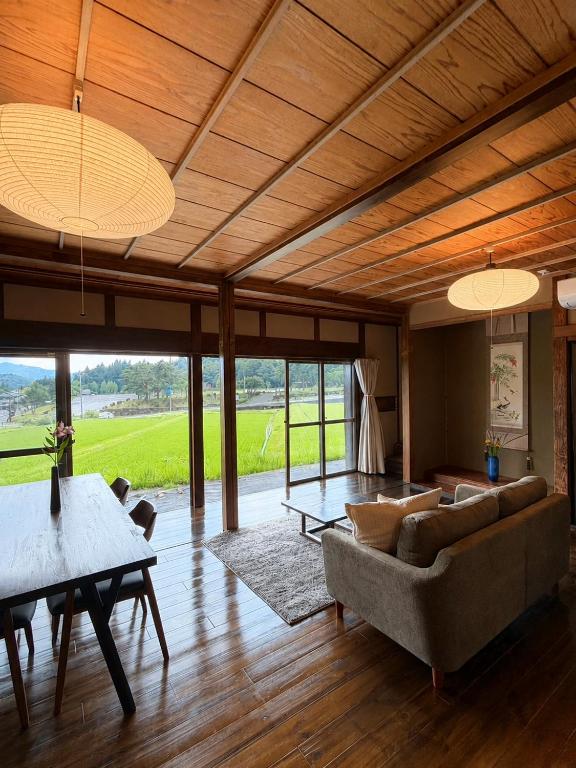 a living room with a couch and a table at Yanagiya Iri in Nakatsugawa