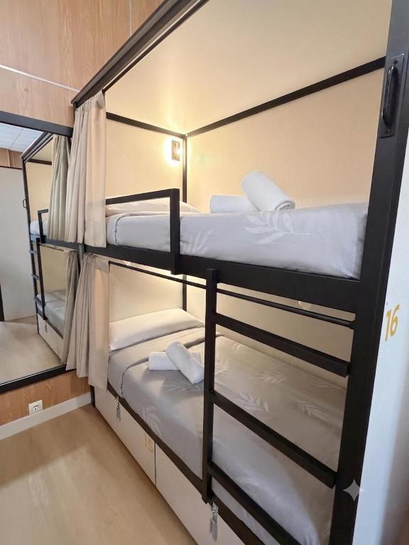 a couple of bunk beds in a room at As Baladas Hostel in Barro