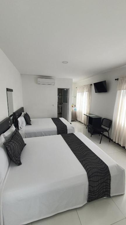 a hotel room with two beds and a piano at Euros Hotel in El Bordo
