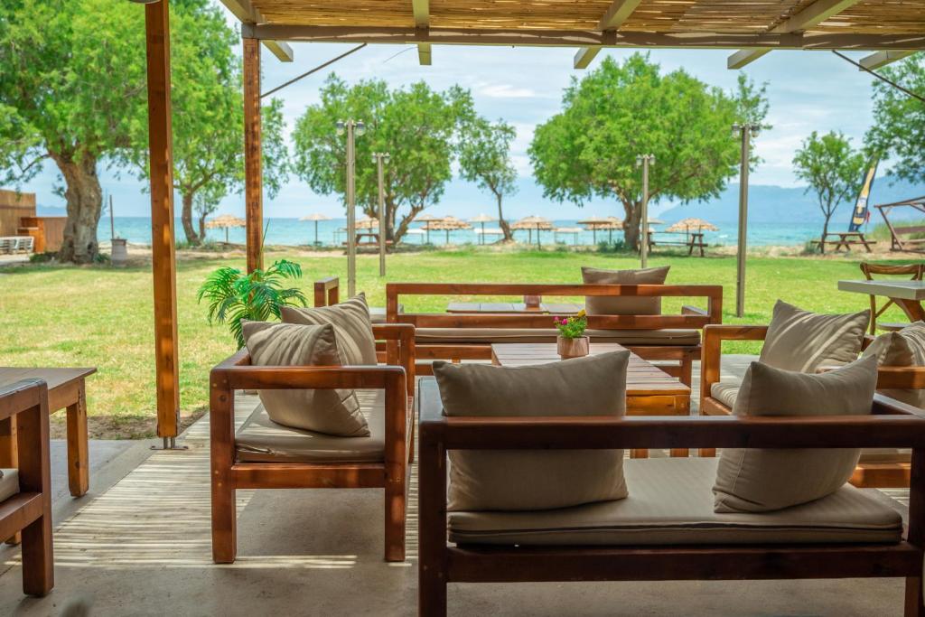 a patio with chairs and tables and a view of the ocean at Naya in Kissamos
