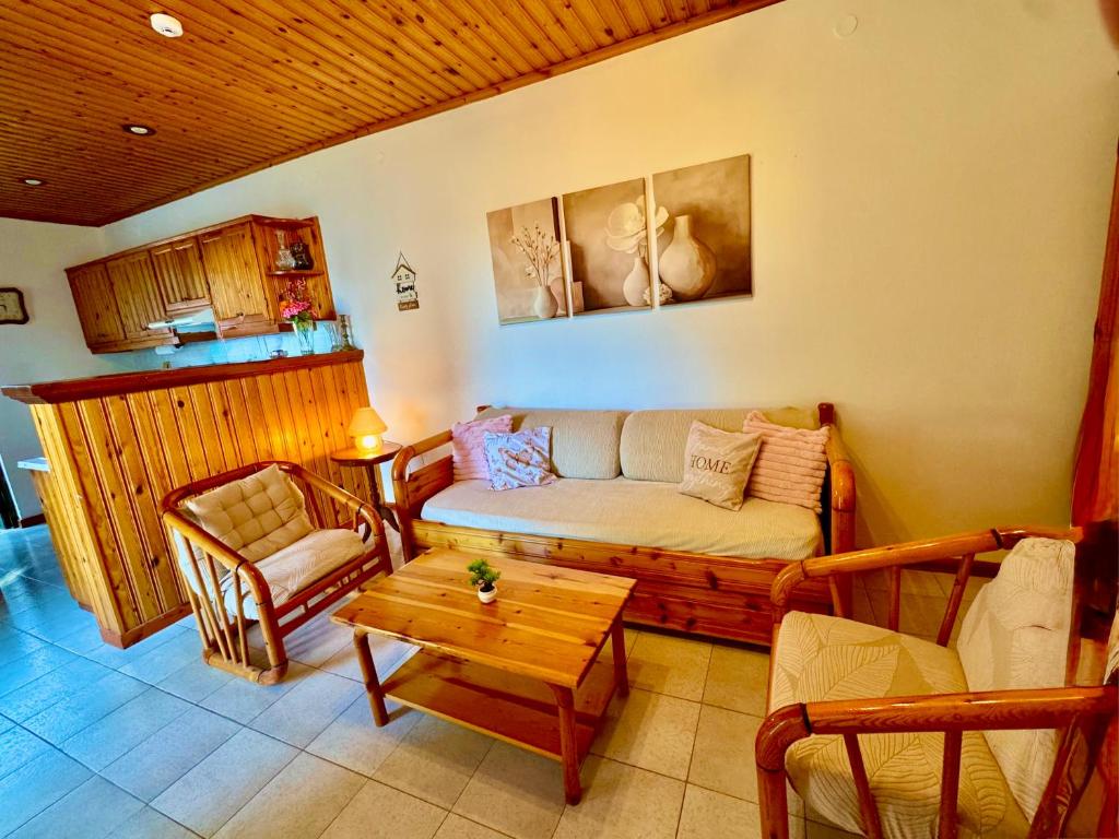 a living room with a couch and a table at Gradakia Cottages 2 in Argostoli
