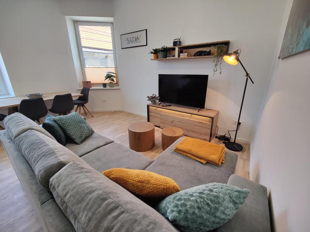 a living room with a couch and a television at Apartment Sarah LIL SIS in Tulln