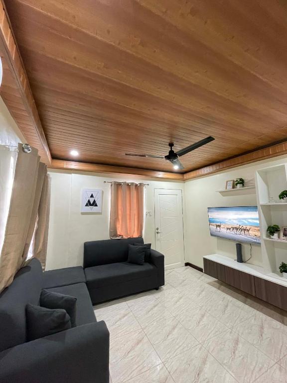 a living room with a couch and a flat screen tv at Brian Castle in Tagum
