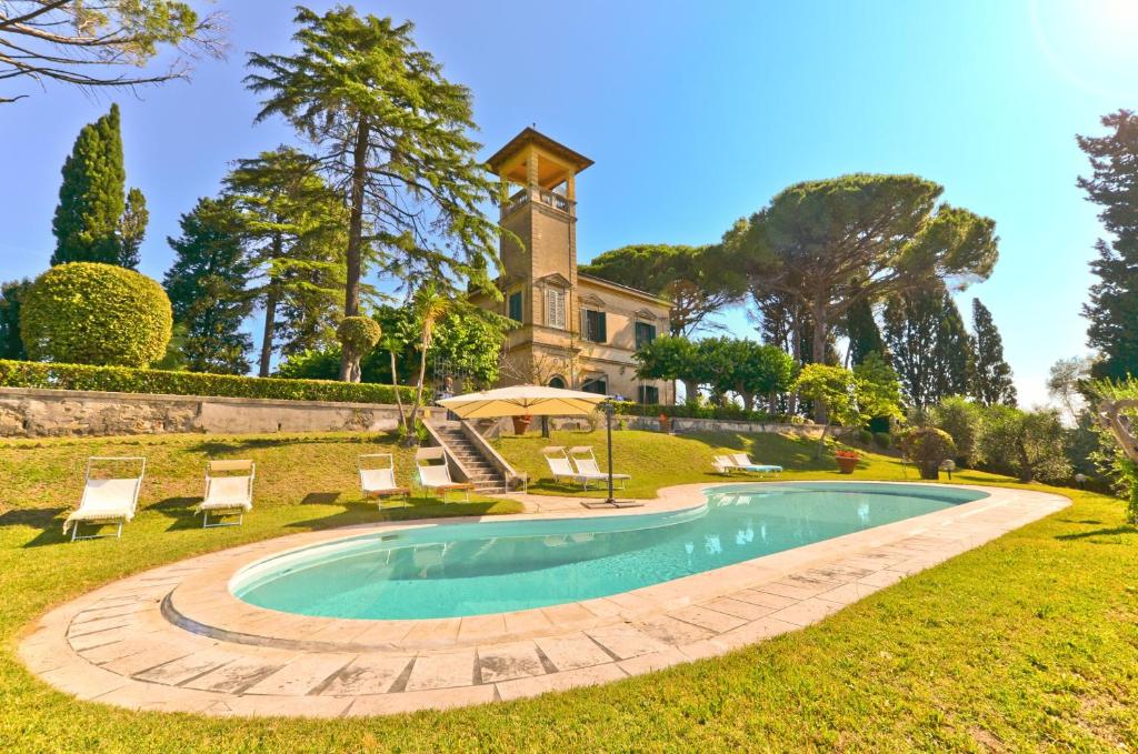 an estate with a swimming pool in front of a house at Villa Bellavista - Tuscany panoramic view in Crespina