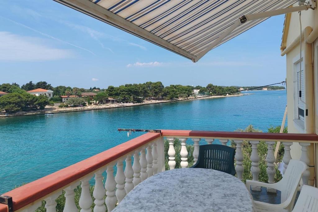 a balcony with a view of the water at Apartment Ugljan 846b in Ugljan
