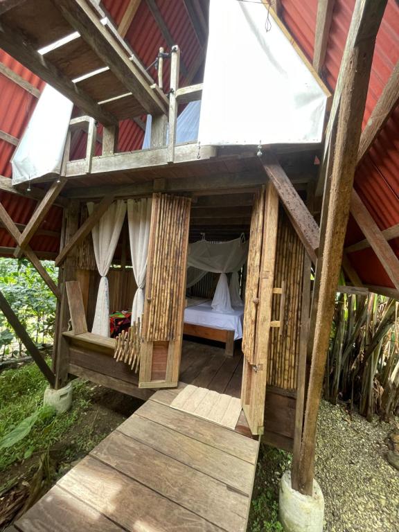 a room in a tree house with a bed in it at Salvaje trip in Nuquí