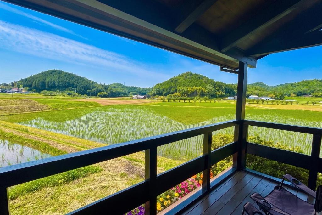 a view from the porch of a house with a view of a field at Setouchi Retreats Sera Highlands in Egi