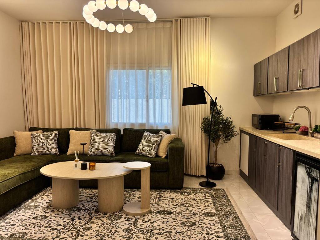 a living room with a couch and a table at Olive home in Al Khobar