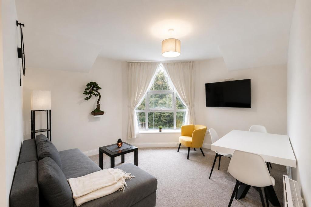 a living room with a couch and a table and a window at Waterford Triangle Apartment in Waterford