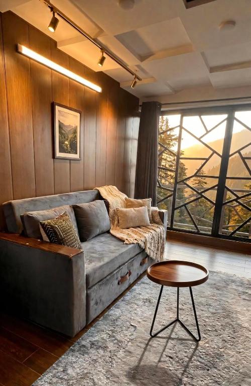 a living room with a couch and a table at Cecil Apartments On Mall Road Murree in Murree