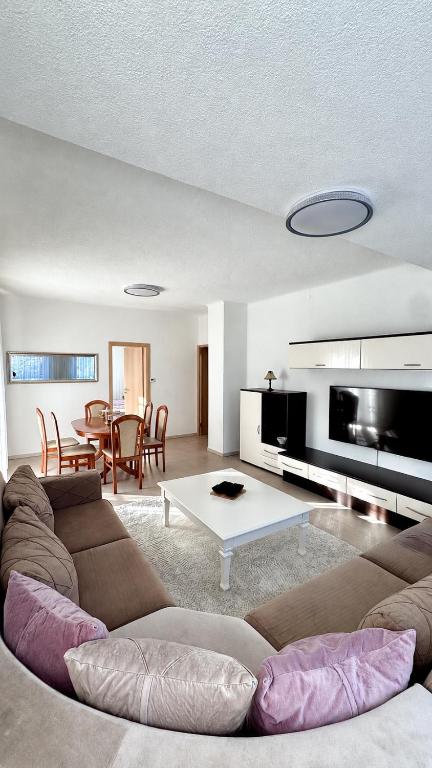 a living room with a couch and a table at Four Rooms Allgäu Apartment in Wangen im Allgäu