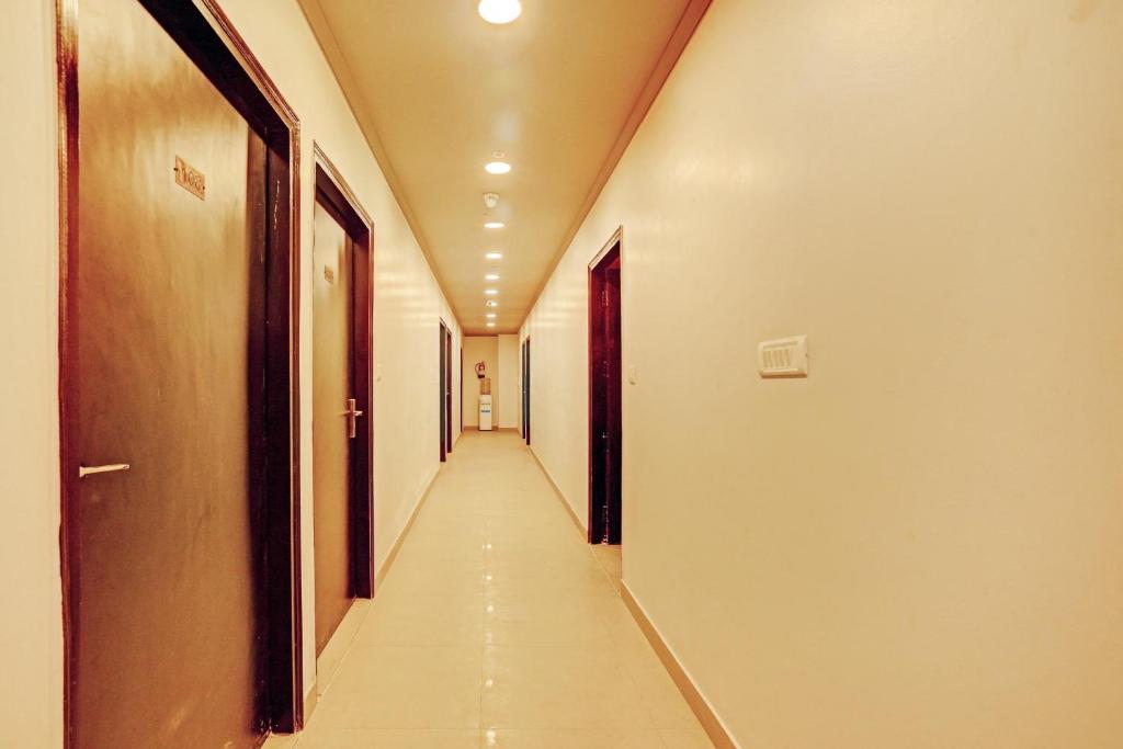 a corridor of an empty hallway in a building at Collection O One Hotel in Ghaziabad
