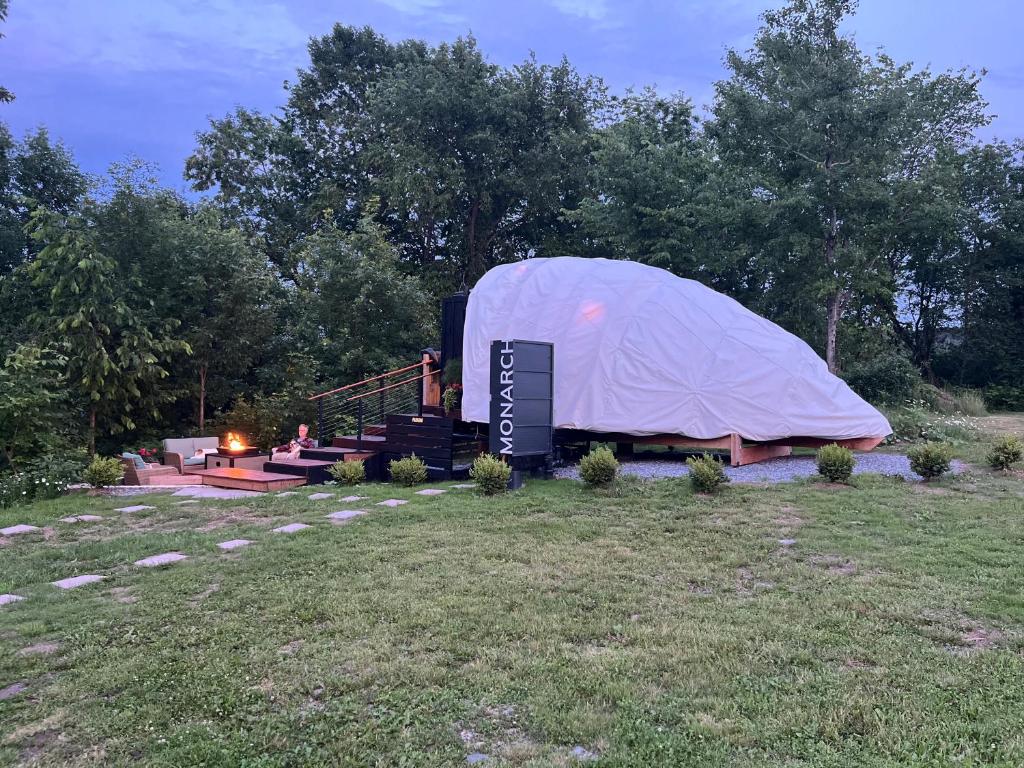 a tent with a sign in a field at Fenlea Resort Glamping Cocoon in Hampton