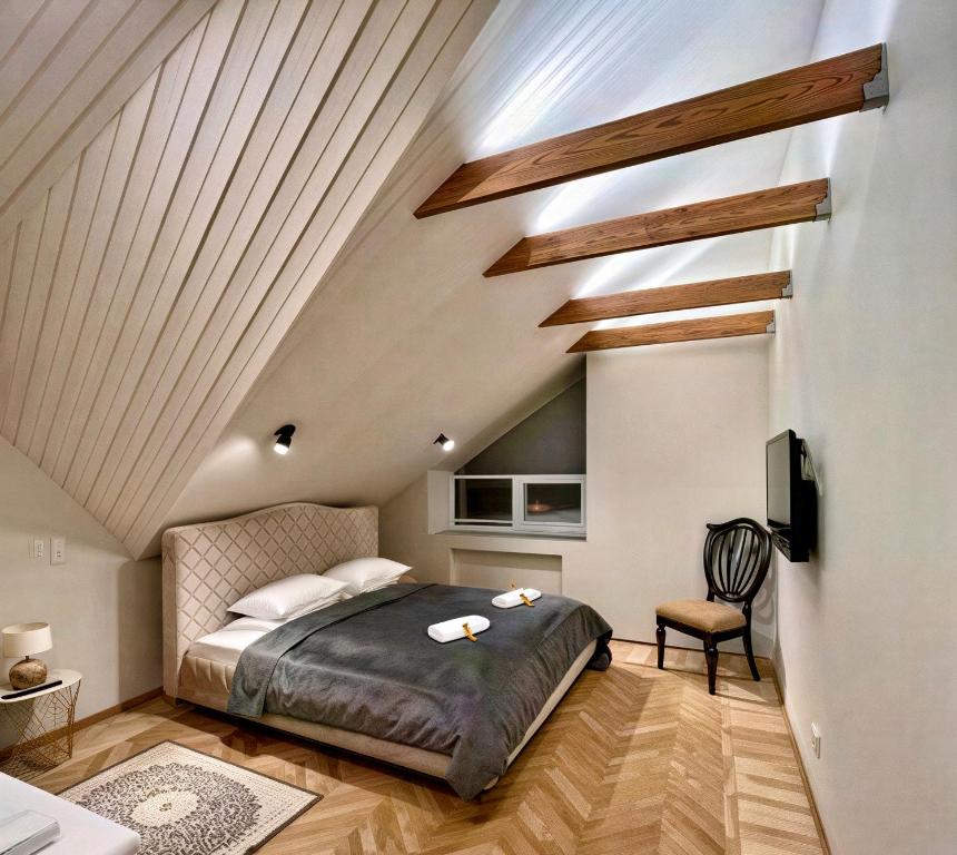a bedroom with a bed in a attic at Saules apartment Klaipeda in Klaipėda