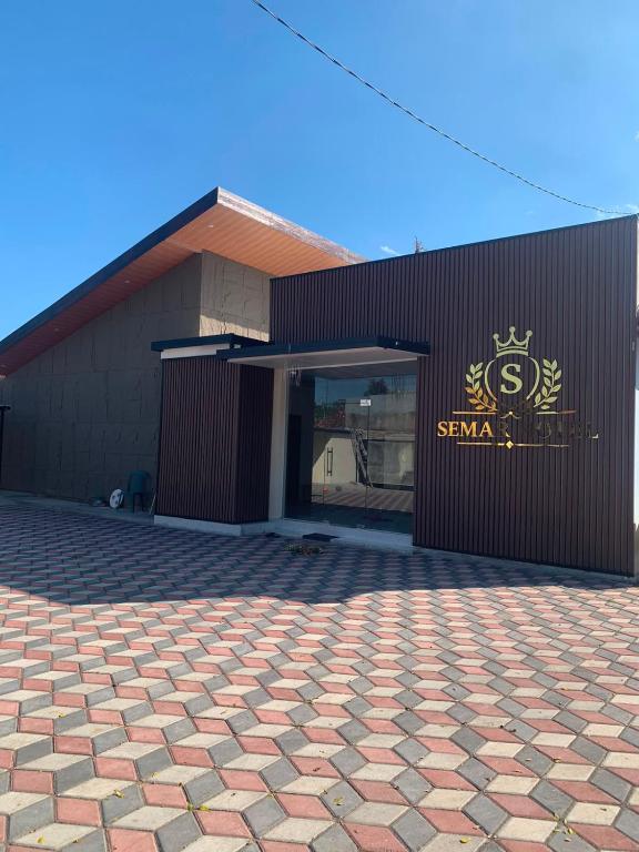 a building with a sign on the side of it at Semar Hotel in Tjakranegara