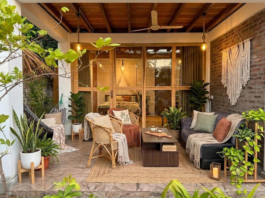 a patio with a couch and a table at Arcadia villas Arugambay in Arugam Bay