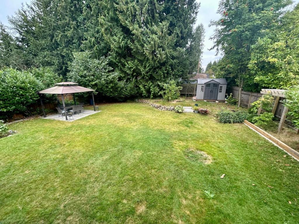an aerial view of a yard with an umbrella at Bright & Cozy Garden Level Suite in North Vancouver