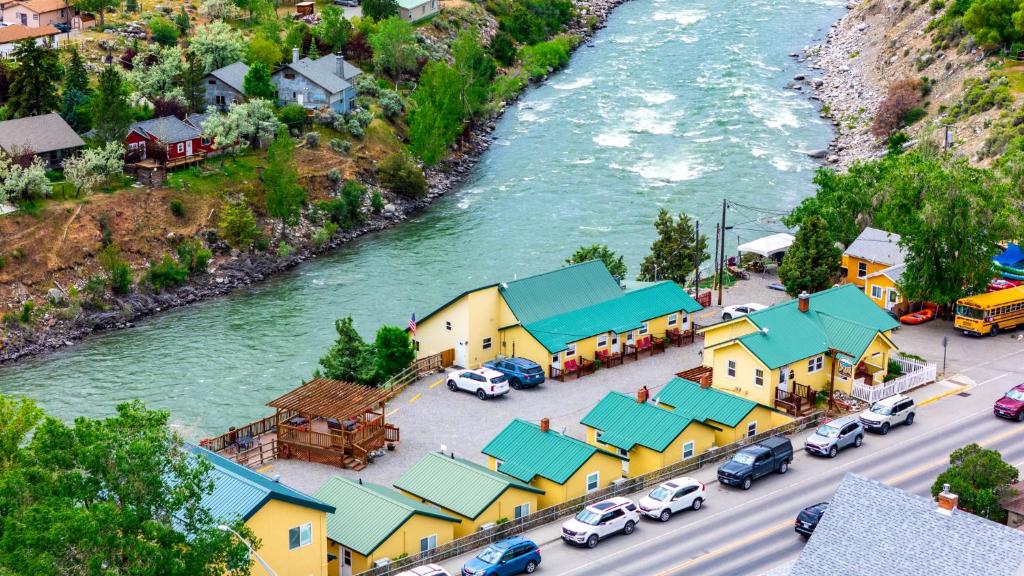 an aerial view of a town next to a river at Yellowstone Riverside Cottages in Gardiner
