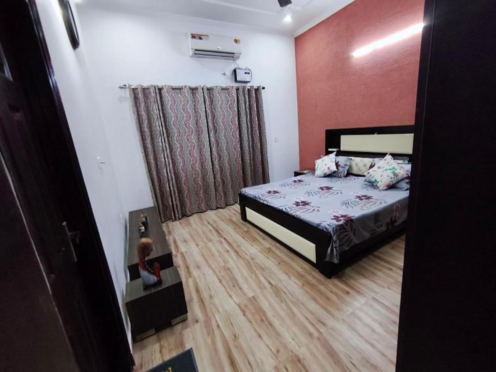 a bedroom with a bed and a child sitting in a drawer at Comfy Stay in Dehradun