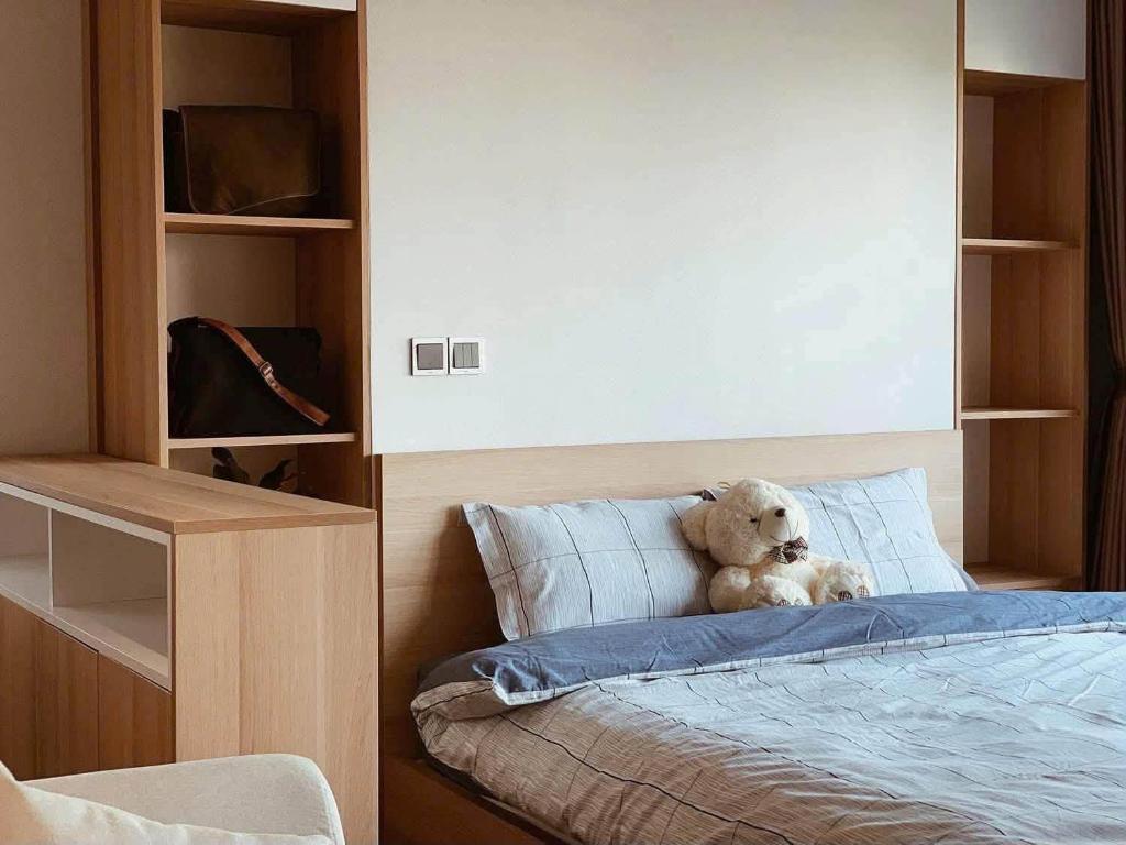 a teddy bear sitting on top of a bed at Ronaldo Palacios in Pagadian