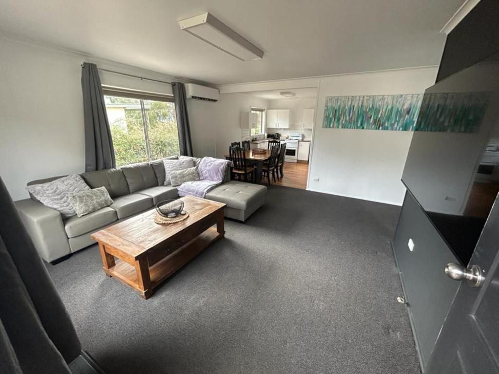 a living room with a couch and a coffee table at Comara Jindabyne Unit 1 in Jindabyne