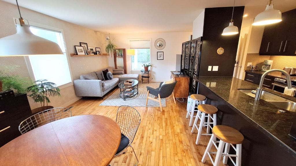 a kitchen and living room with a table and chairs at Charming Inner City Home in Calgary