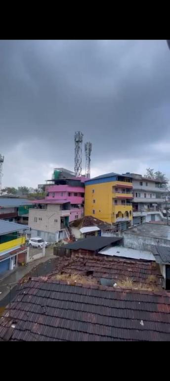 a view of a city with buildings in the background at Instahomestay in Vālpārai