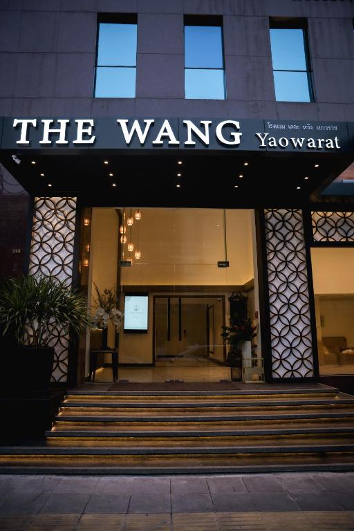 a building with a sign that reads the wavingowment at The Wang Yaowarat Hotel in Bangkok