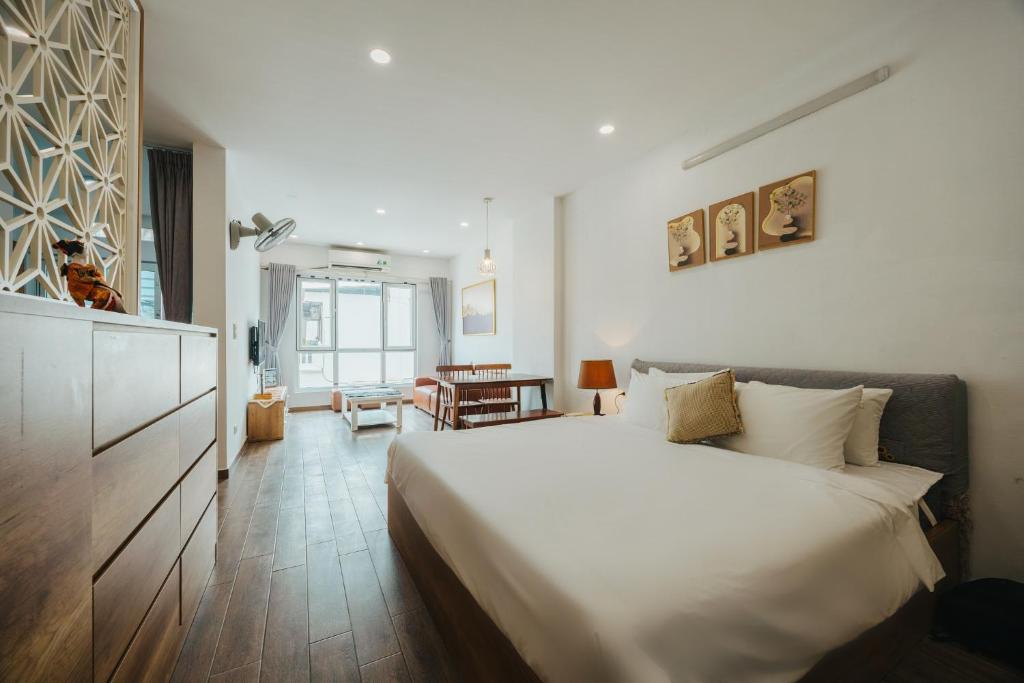 a bedroom with a large white bed in a room at BOHO Homestay No10 Alley 08 Ton That Thiep - Hanoi in Hanoi