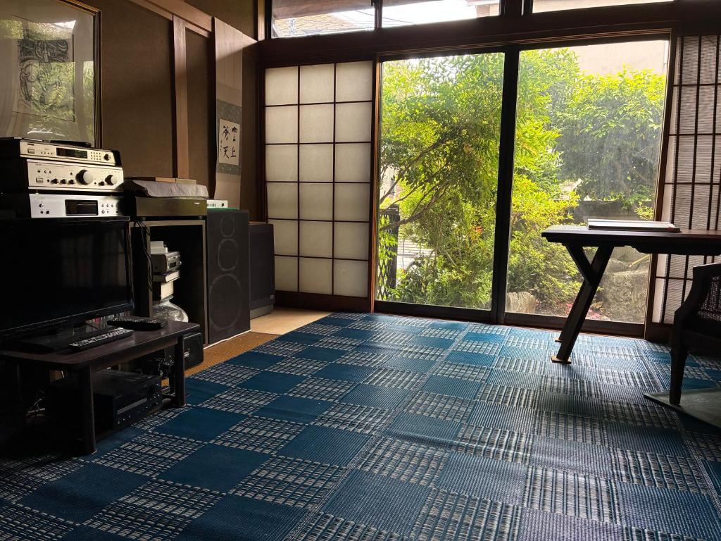 a living room with a blue tiled floor and a tv at スペースigusa専用寝室2室に2名様3泊よりマンスリー割引がおすすめ in Tokyo