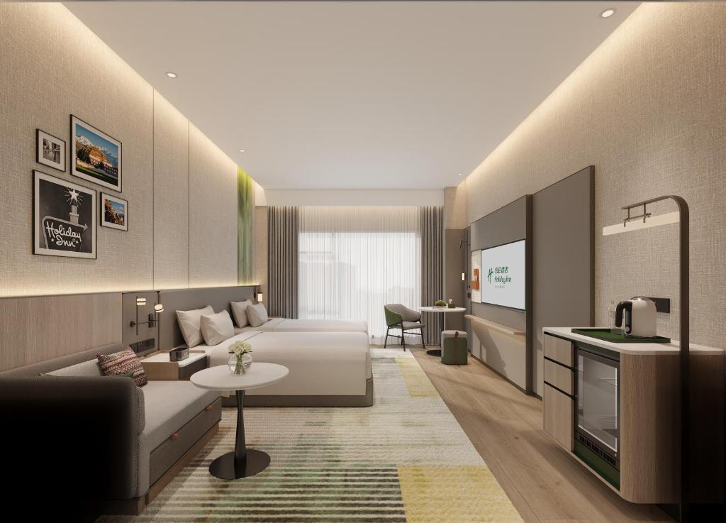 a hotel room with a bed and a couch at Holiday Inn Bayanbulak by IHG in Bayanbulak