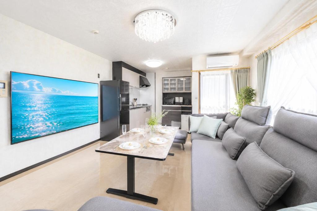 a living room with a couch and a table at HOTEL StayLuck MARUGAME - 無料駐車場 in Marugame