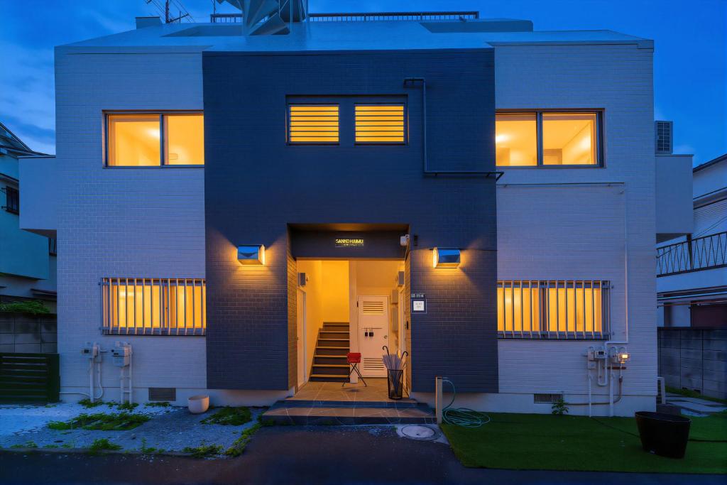 a house with the front door lit up at night at JUJO Inn in Tokyo