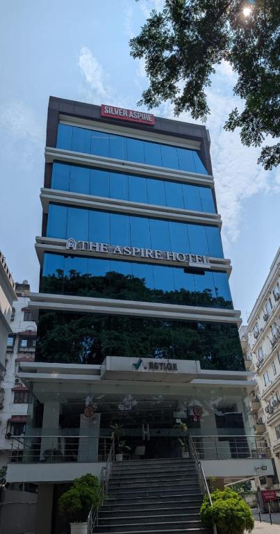 a tall building with a sign on top of it at The Aspire Hotel Guwahati in Guwahati